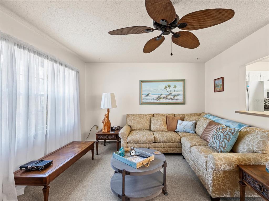 11735 Boynton Lane, Unit 11735 New Port Richey, FL 34654 - Photo 6 of 25 a living room with furniture and a large window