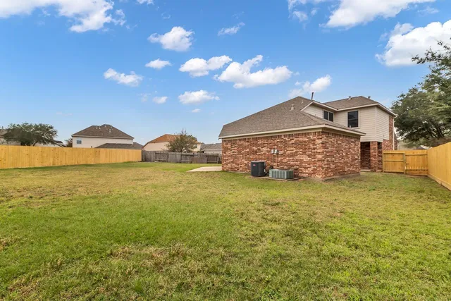 a front view of house with outdoor space and trees