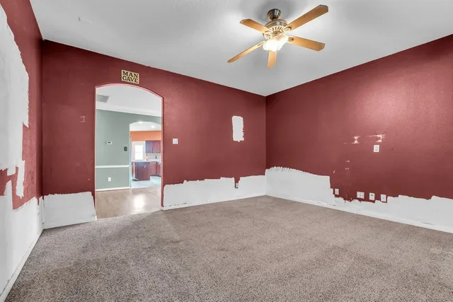 a view of a livingroom with a ceiling fan and a chandelier fan