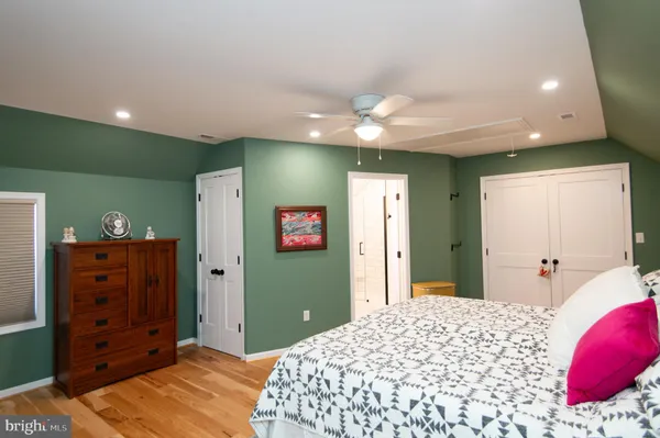 a bedroom with a large bed and a chandelier