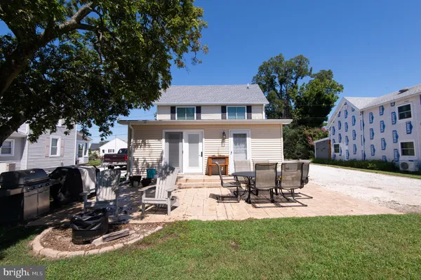 a view of a house with backyard porch and sitting area
