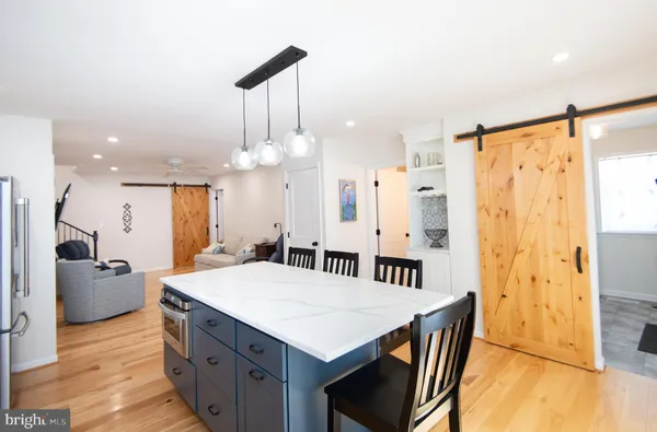 a kitchen with stainless steel appliances kitchen island a chandelier