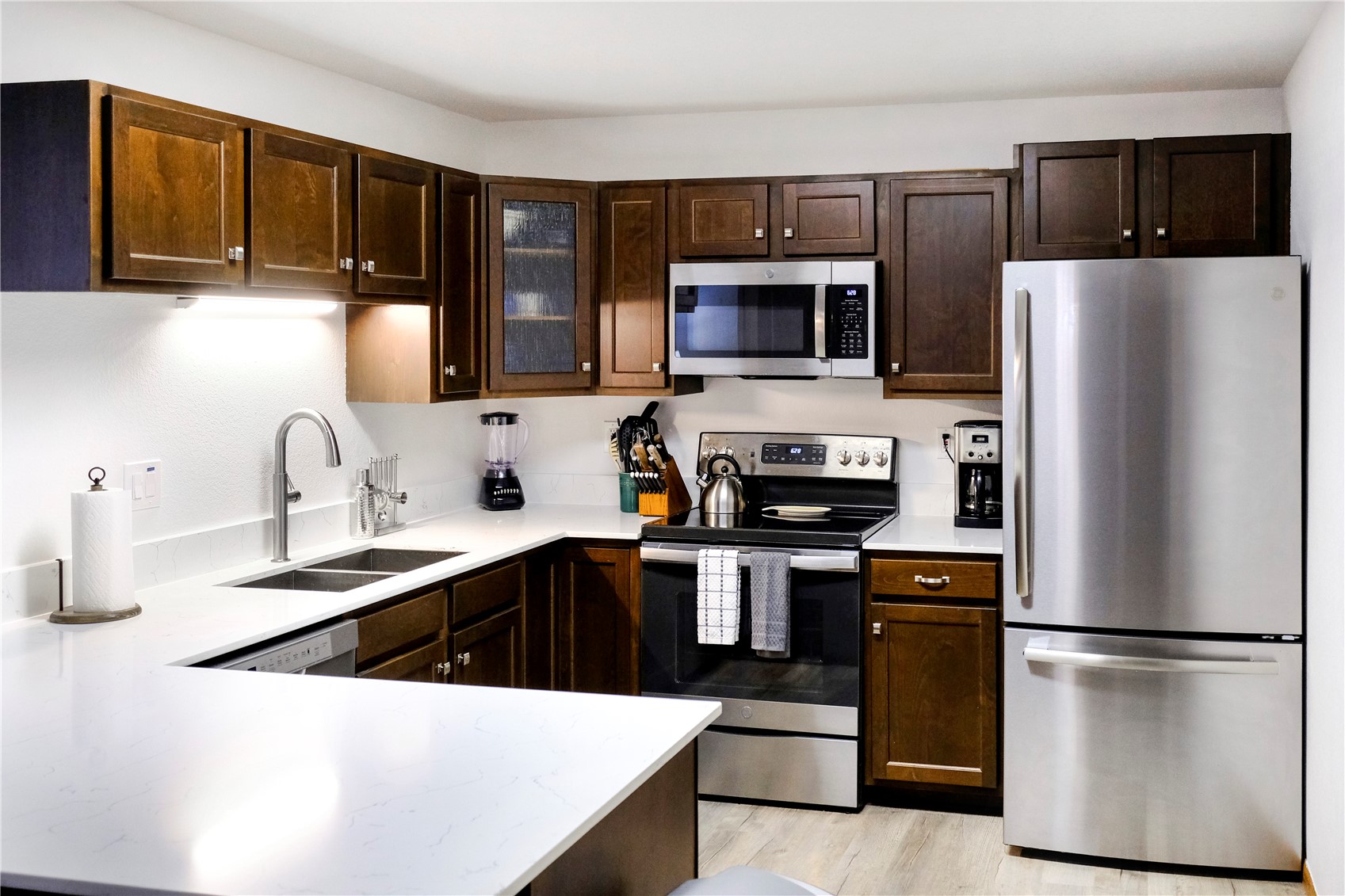 23034 Highway 6, Unit 305 Keystone, CO 80435 - Photo 7 of 27 a kitchen with stainless steel appliances a refrigerator stove microwave and sink