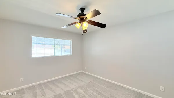 a view of a chandelier fan and a refrigerator in a room