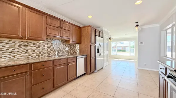a kitchen with stainless steel appliances granite countertop a refrigerator and a sink