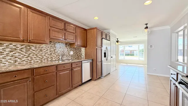 a kitchen with stainless steel appliances granite countertop a refrigerator and a sink
