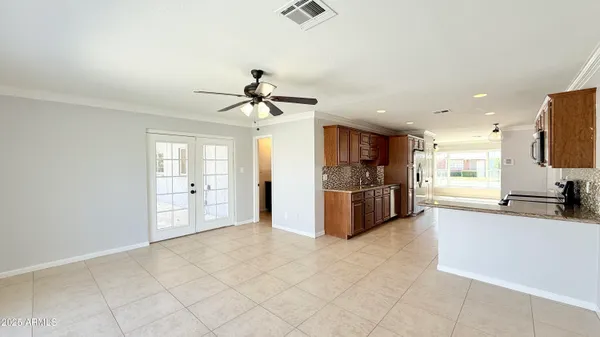 a large kitchen with stainless steel appliances a sink and a refrigerator