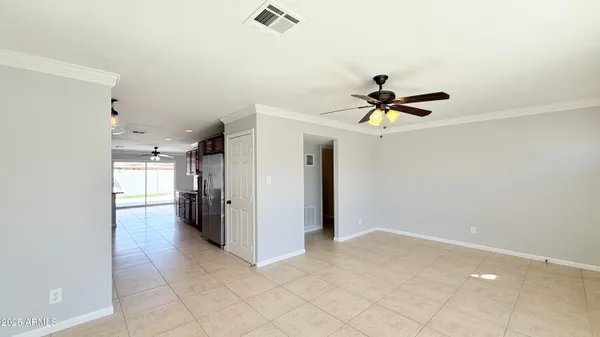 a view of a livingroom with a ceiling fan and carpet