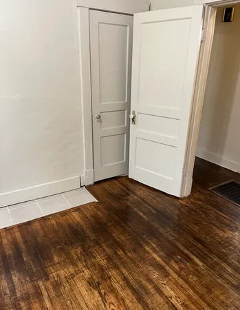 a view of walk in closet with wooden floor