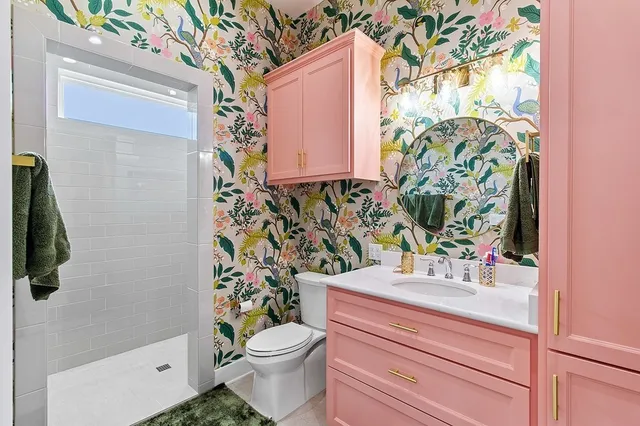a bathroom with a toilet sink and mirror