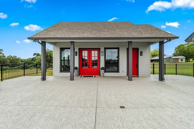a view of a house with porch and a floor to ceiling window