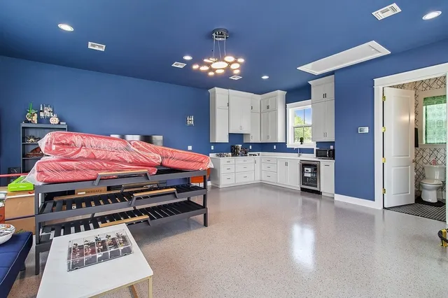 a bedroom with furniture and a chandelier