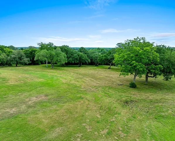 a view of a swimming pool with a yard
