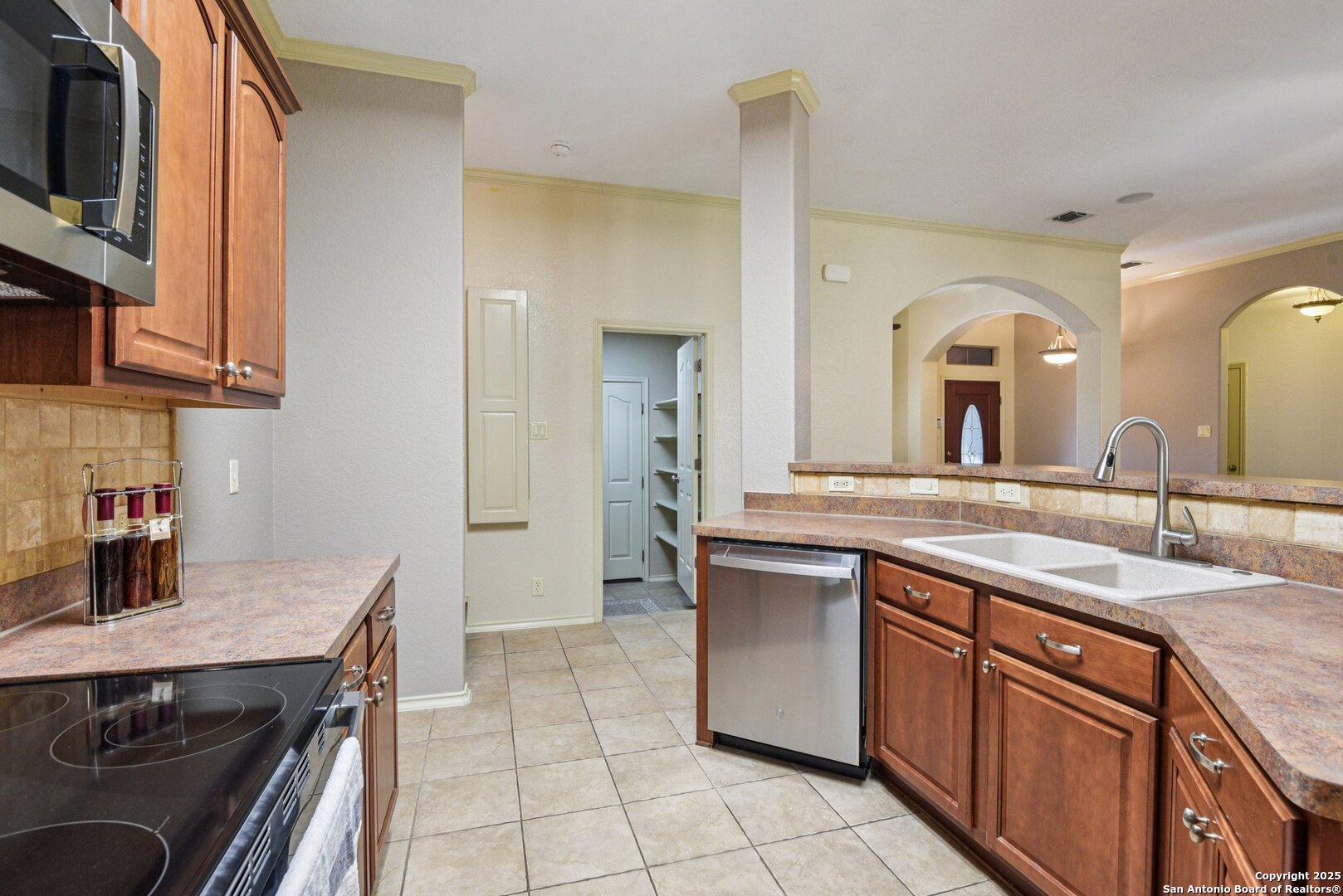 3524 Angora Trail Schertz, TX 78154 - Photo 9 of 25 a kitchen with a sink and a stove top oven with wooden floor