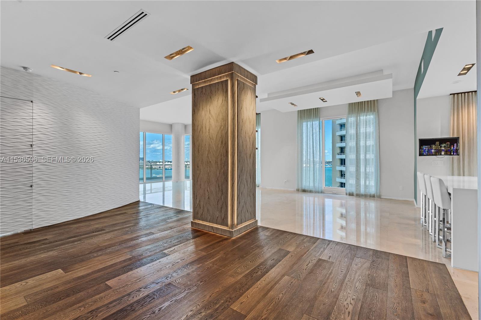 900 Brickell Key Boulevard, Unit 1002 Miami, FL 33131 - Photo 16 of 87 a view of a kitchen with wooden floor and a refrigerator