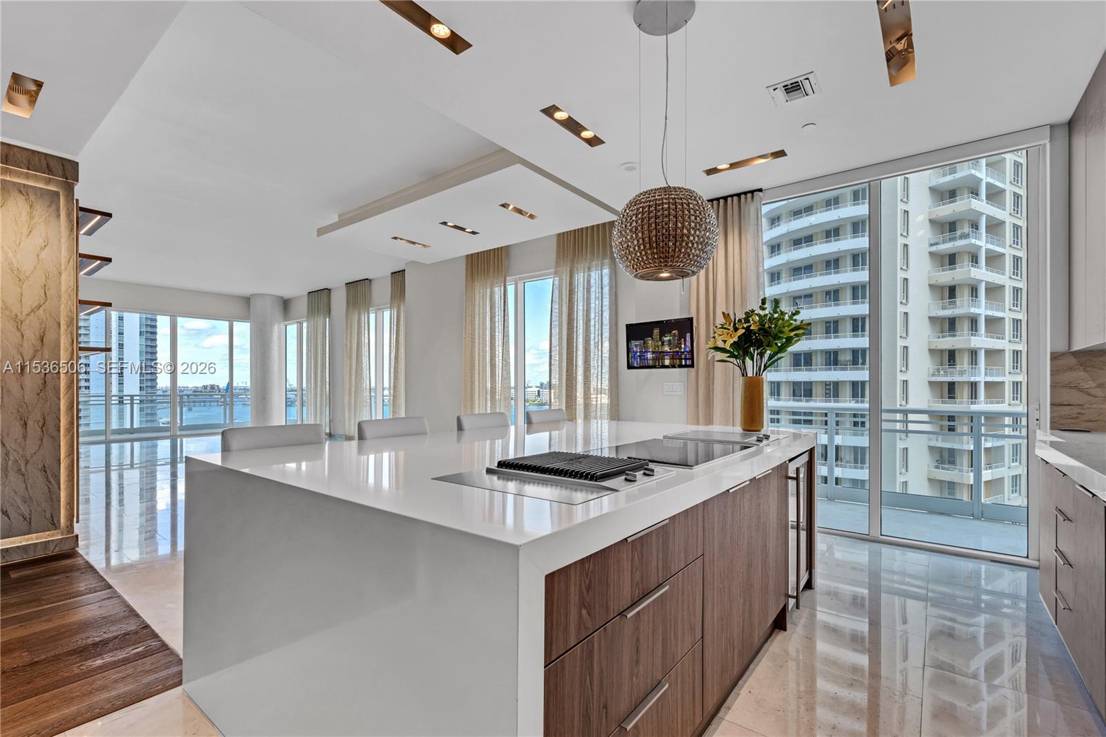 900 Brickell Key Boulevard, Unit 1002 Miami, FL 33131 - Photo 29 of 87 a kitchen with stainless steel appliances granite countertop a stove a sink and a refrigerator