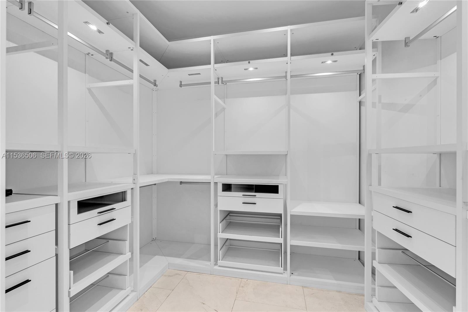 900 Brickell Key Boulevard, Unit 1002 Miami, FL 33131 - Photo 34 of 87 a view of walk in closet with empty racks