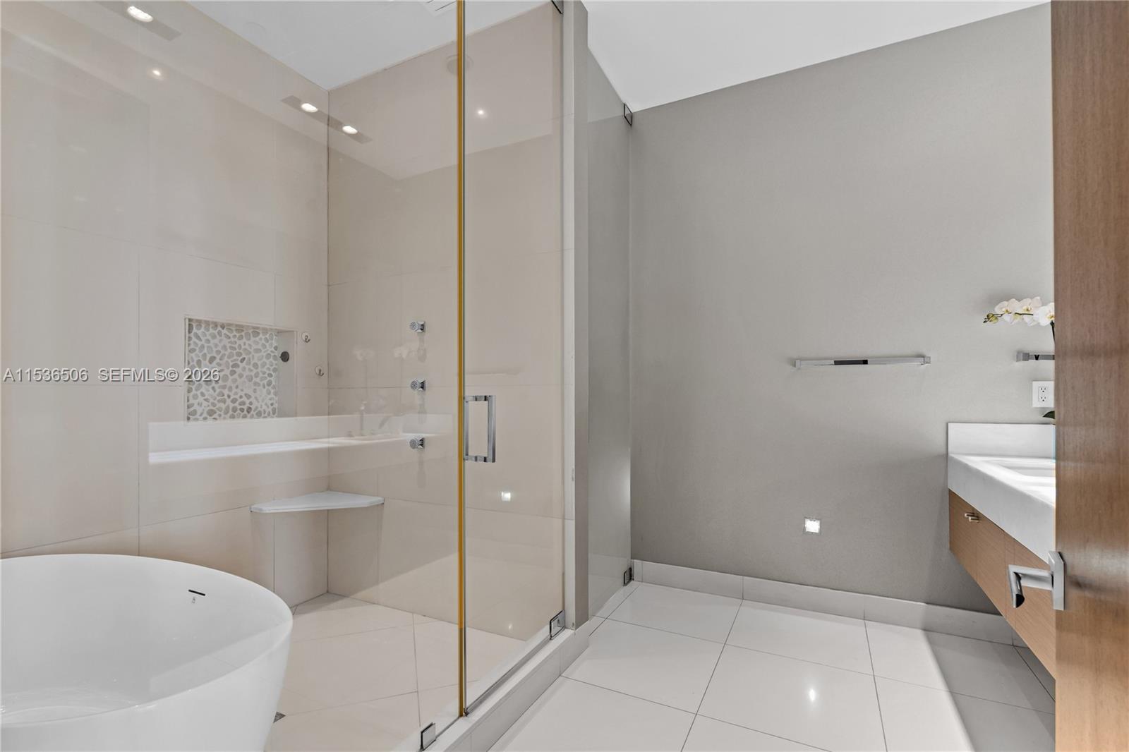 900 Brickell Key Boulevard, Unit 1002 Miami, FL 33131 - Photo 35 of 87 a bathroom with a bathtub and a shower