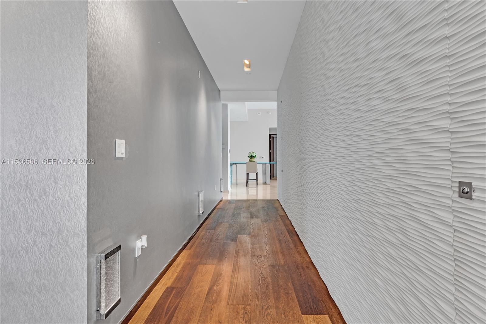 900 Brickell Key Boulevard, Unit 1002 Miami, FL 33131 - Photo 39 of 87 a view of a hallway with wooden floor