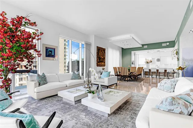 a living room with furniture and flowers