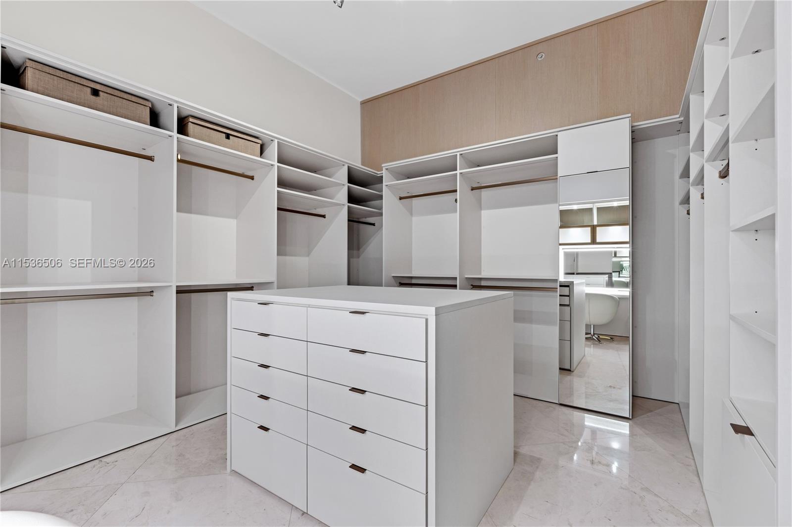 900 Brickell Key Boulevard, Unit 1002 Miami, FL 33131 - Photo 50 of 87 a kitchen with white cabinets and refrigerator