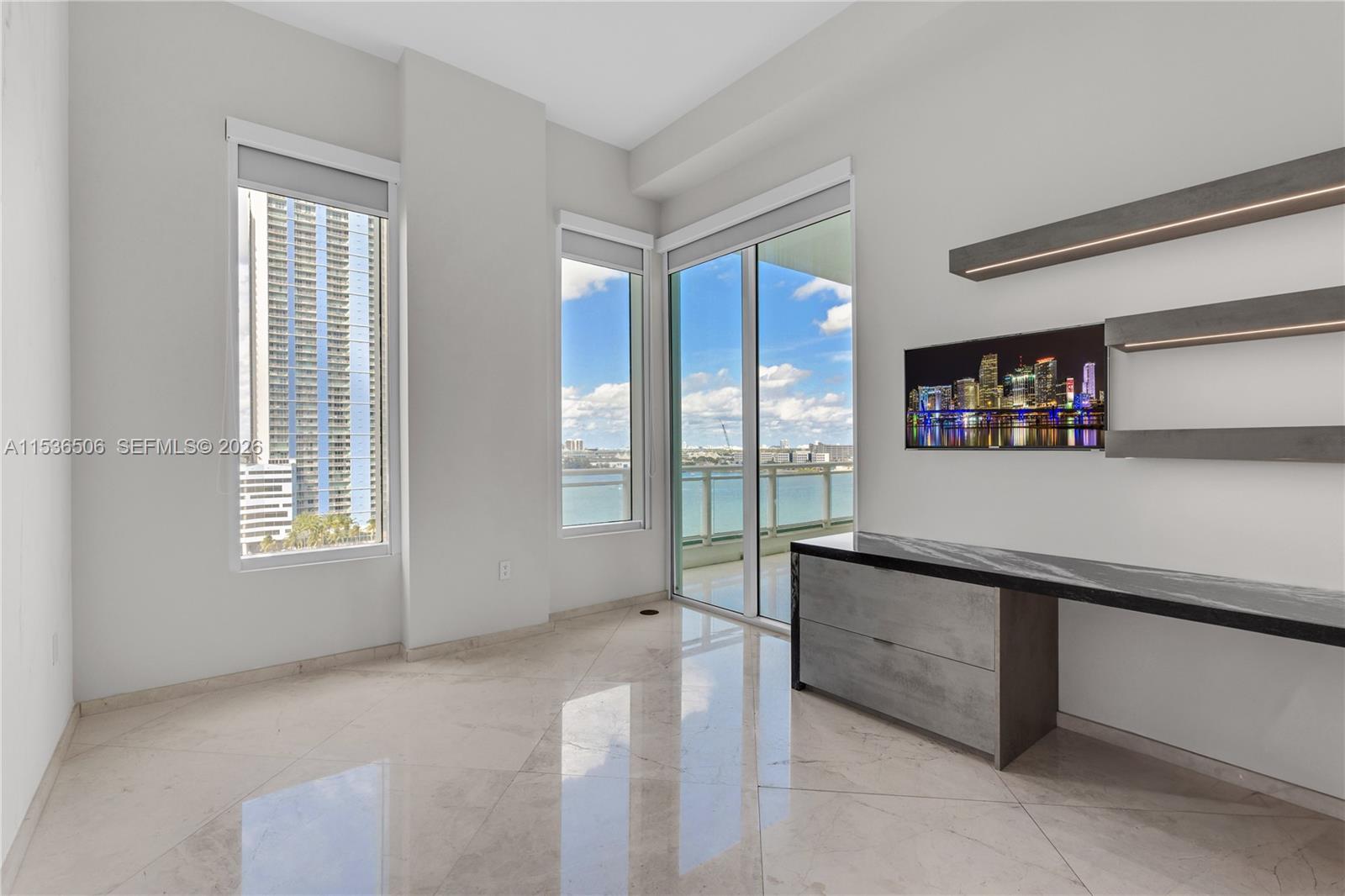 900 Brickell Key Boulevard, Unit 1002 Miami, FL 33131 - Photo 64 of 87 a living room with stainless steel appliances granite countertop a sink and a large window
