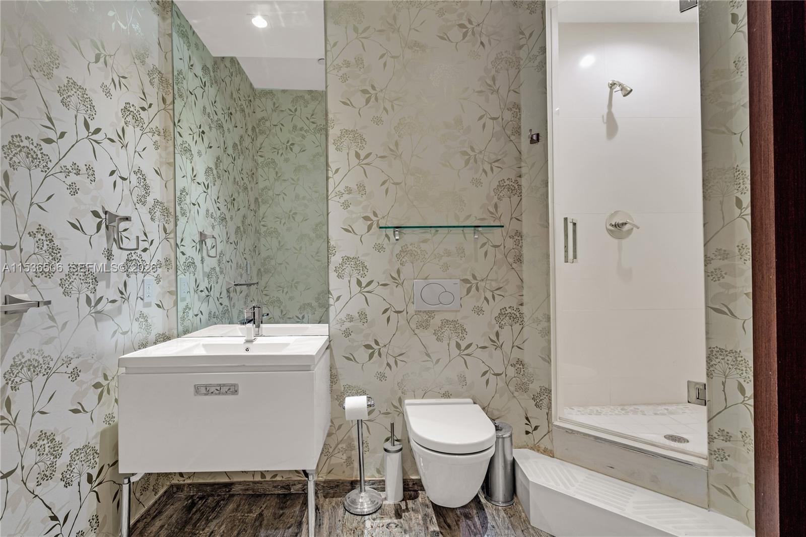 900 Brickell Key Boulevard, Unit 1002 Miami, FL 33131 - Photo 70 of 87 a bathroom with a toilet a sink and shower