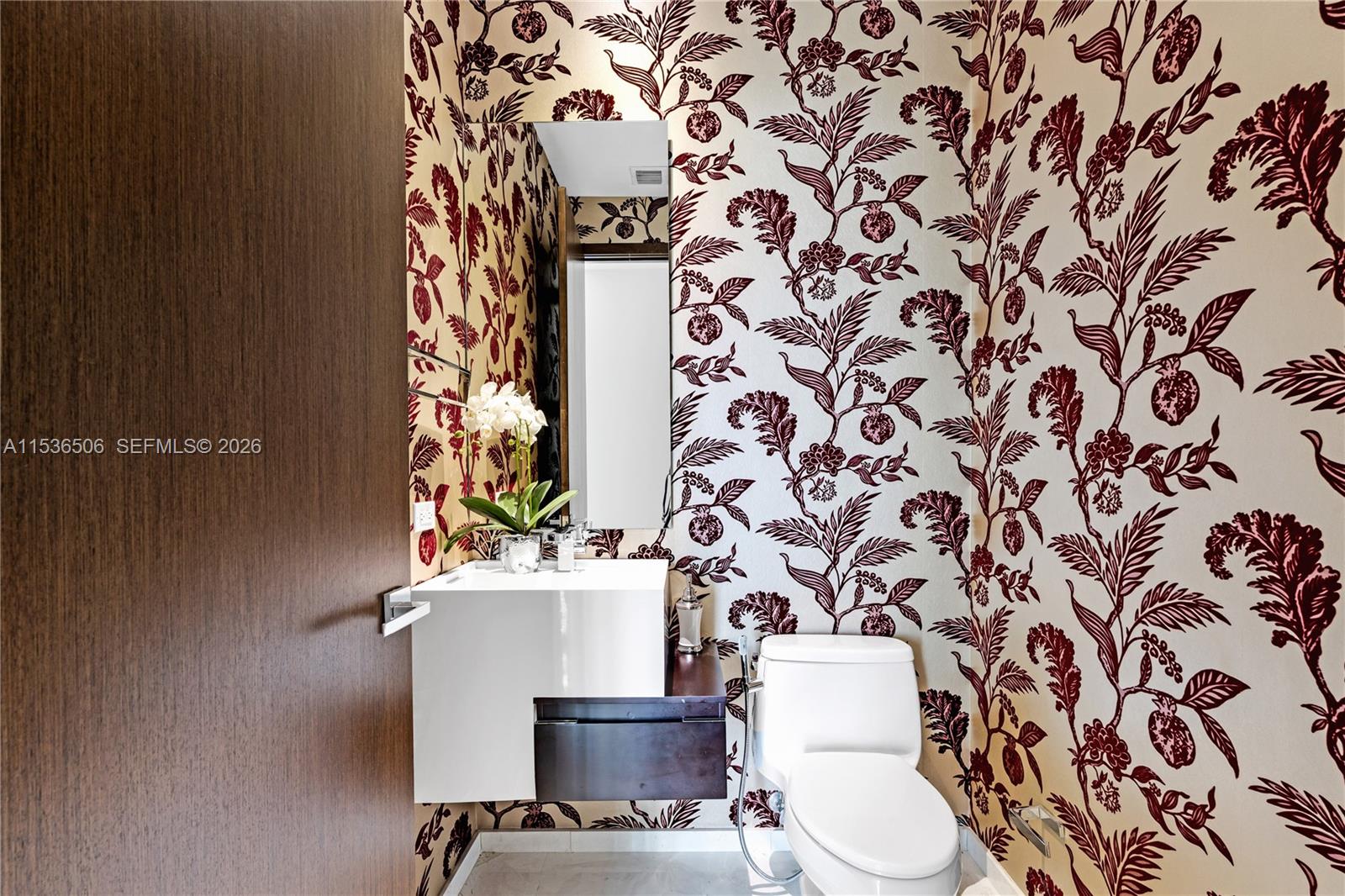 900 Brickell Key Boulevard, Unit 1002 Miami, FL 33131 - Photo 71 of 87 a bathroom with a toilet and a sink