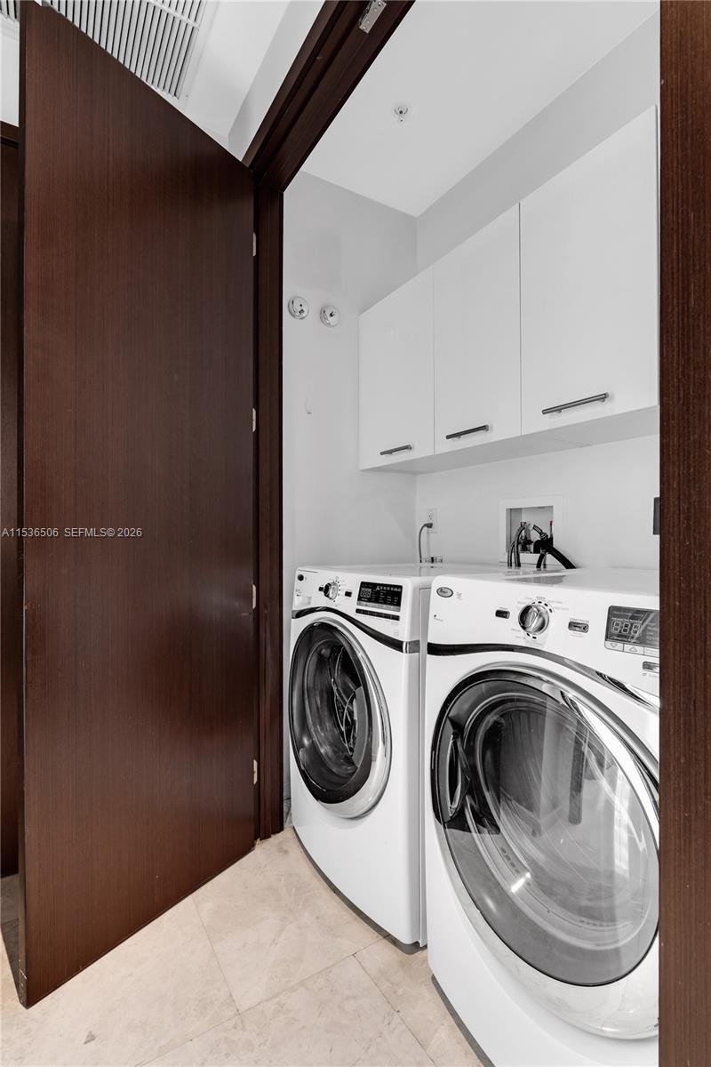 900 Brickell Key Boulevard, Unit 1002 Miami, FL 33131 - Photo 72 of 87 a utility room with sink dryer and washer