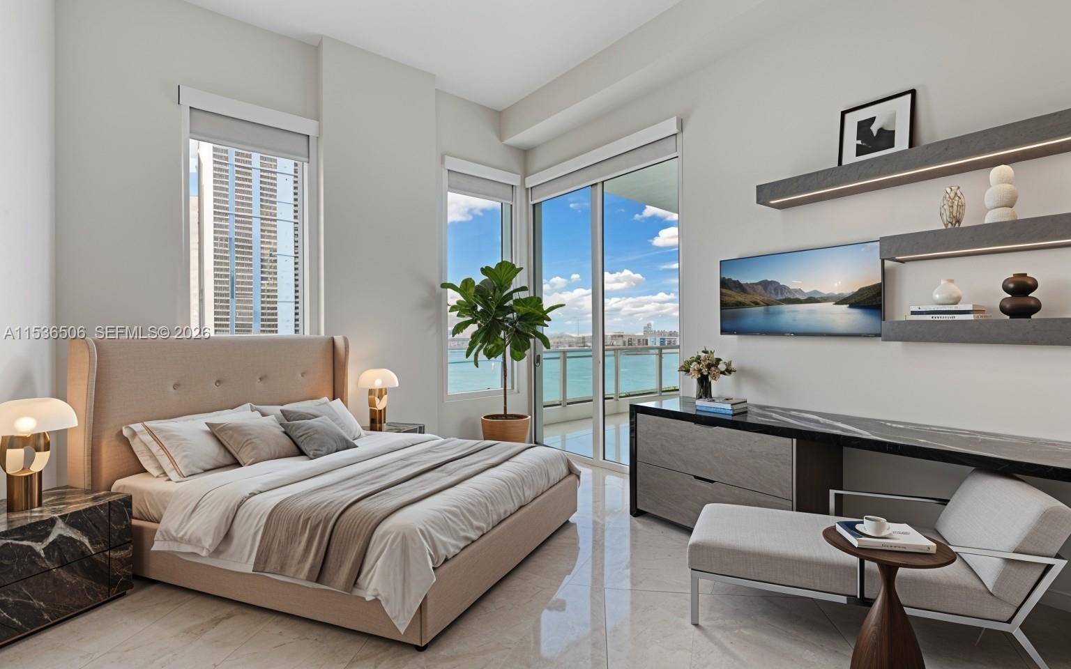 900 Brickell Key Boulevard, Unit 1002 Miami, FL 33131 - Photo 8 of 87 a bedroom with a large bed and a chandelier