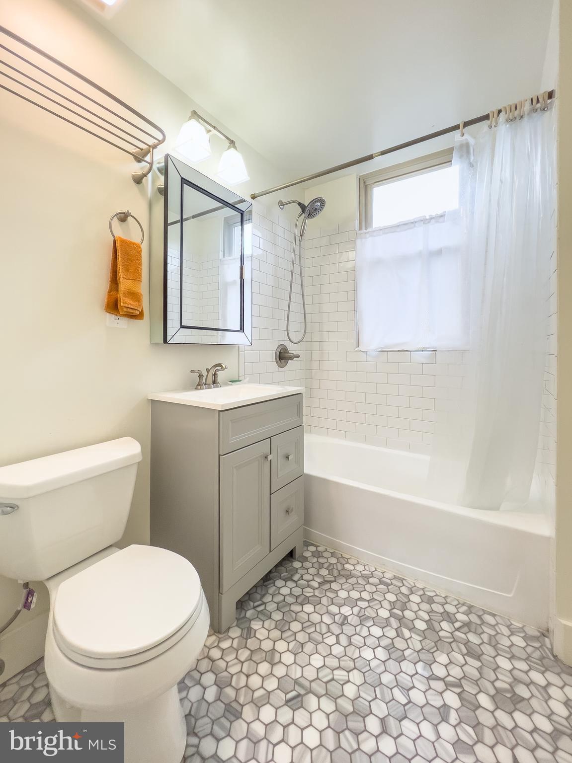 1725 Lanier Place Northwest, Unit 9C Washington, DC 20009 - Photo 14 of 18 a bathroom with a sink toilet and shower
