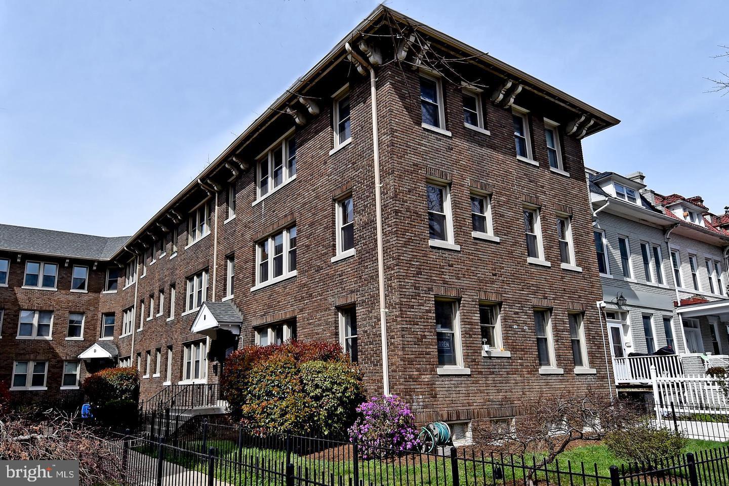 1725 Lanier Place Northwest, Unit 9C Washington, DC 20009 - Photo 2 of 18 a front view of a house with a yard