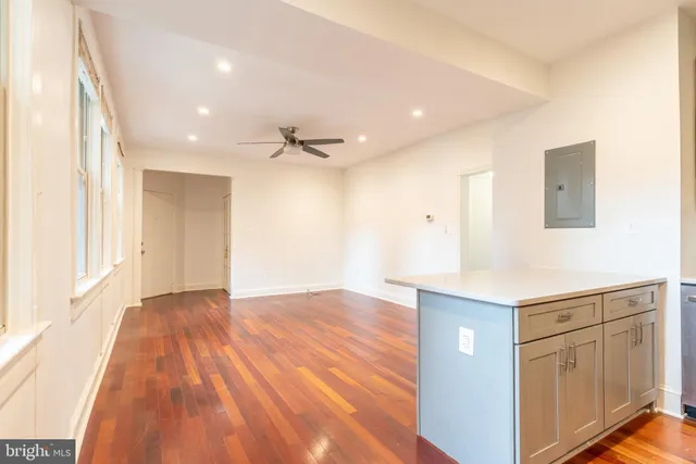 a view of a kitchen cabinets a sink and wooden floor