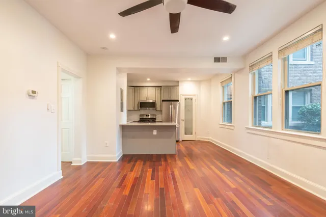 a kitchen with stainless steel appliances a refrigerator and a stove top oven