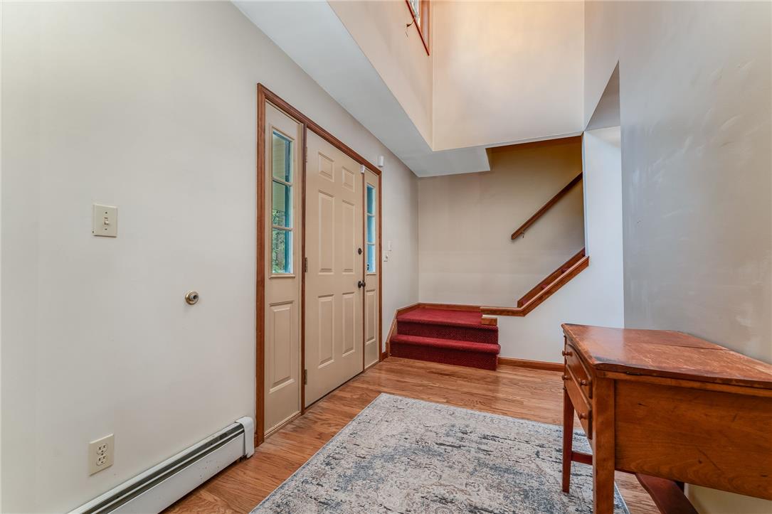 465 Raubsville Road Easton, PA 18042 - Photo 10 of 60 A welcoming entry features hardwood floors and a striking staircase with a rich red runner.