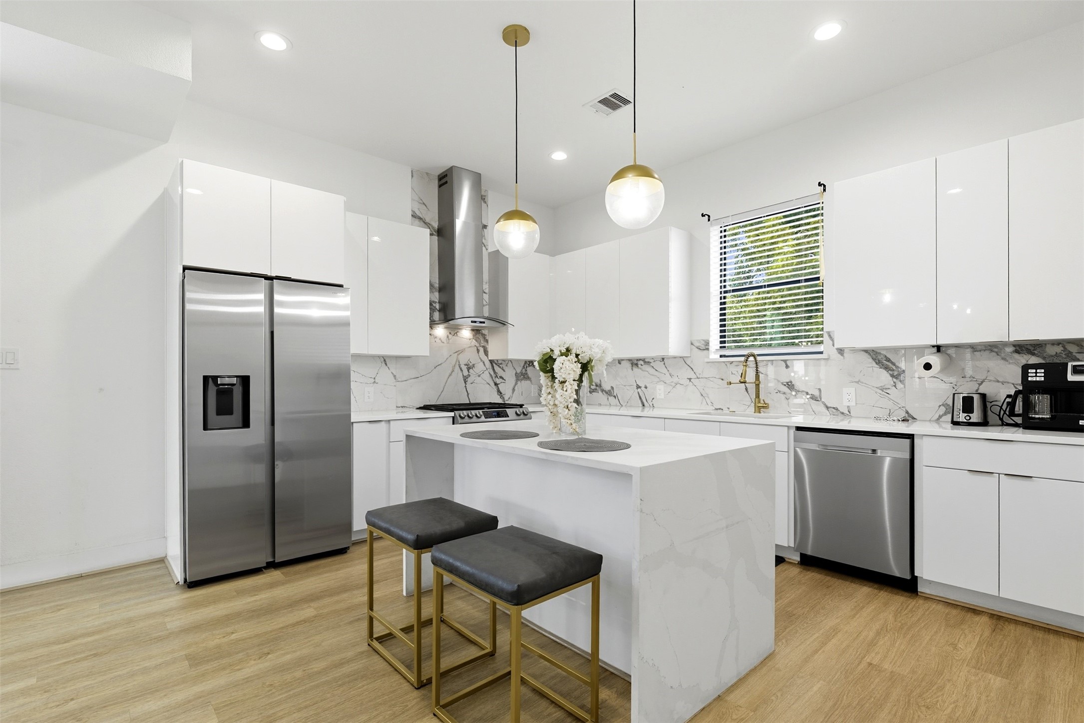 3605 Bremond Street Houston, TX 77004 - Photo 7 of 35 a kitchen with stainless steel appliances granite countertop a sink a stove a refrigerator and island with wooden floor