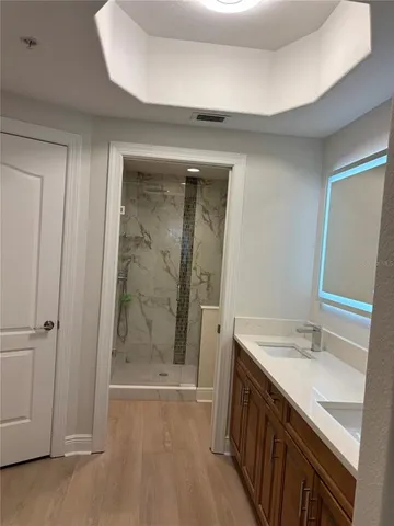 a bathroom with a double vanity sink and a mirror