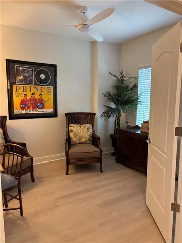 a living room with furniture and a painting on the wall