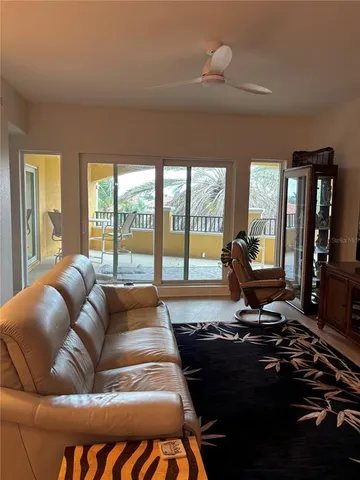 a living room with furniture and a floor to ceiling window