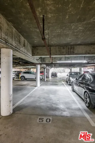a view of parking garage with cars