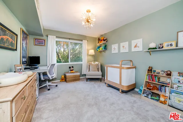 a bedroom with furniture and a flat screen tv