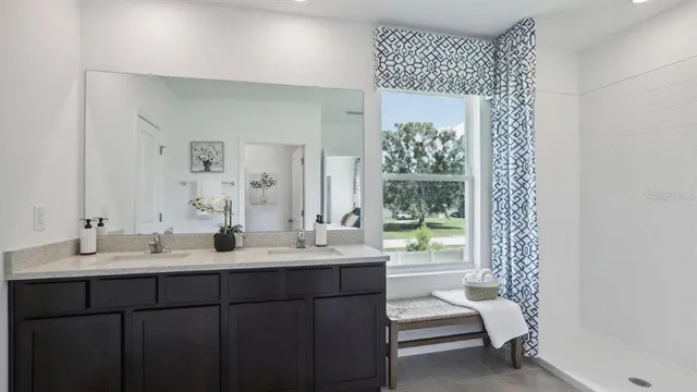 a bathroom with a double vanity sink and mirror