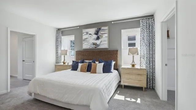 a bedroom with a large bed and a window