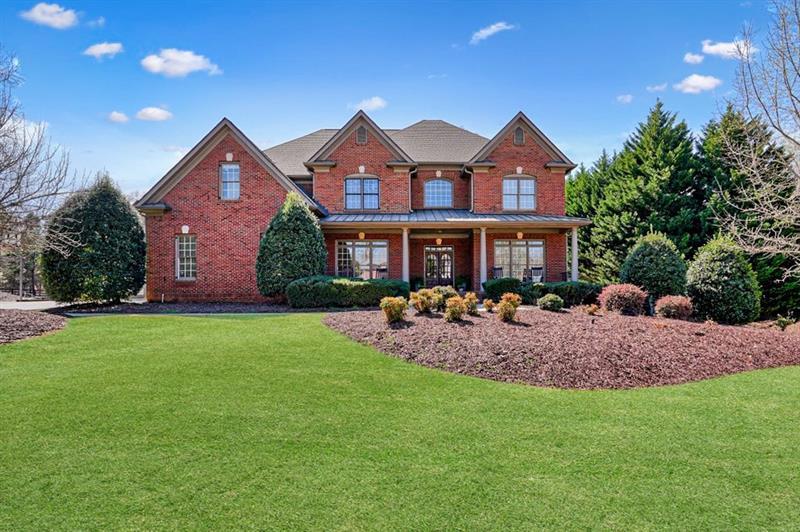 a front view of a house with garden and porch