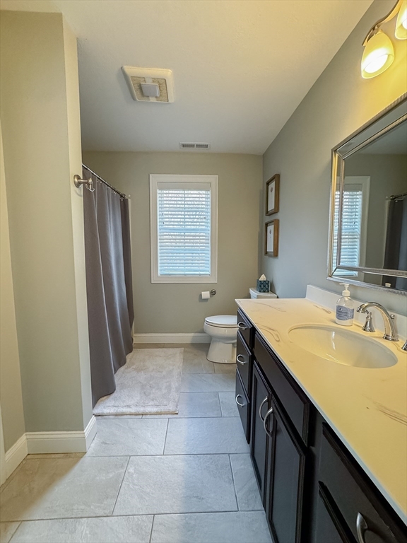 23 Ralph Street Chicopee, MA 01020 - Photo 23 of 42 a spacious bathroom with a granite countertop sink a toilet a mirror and window