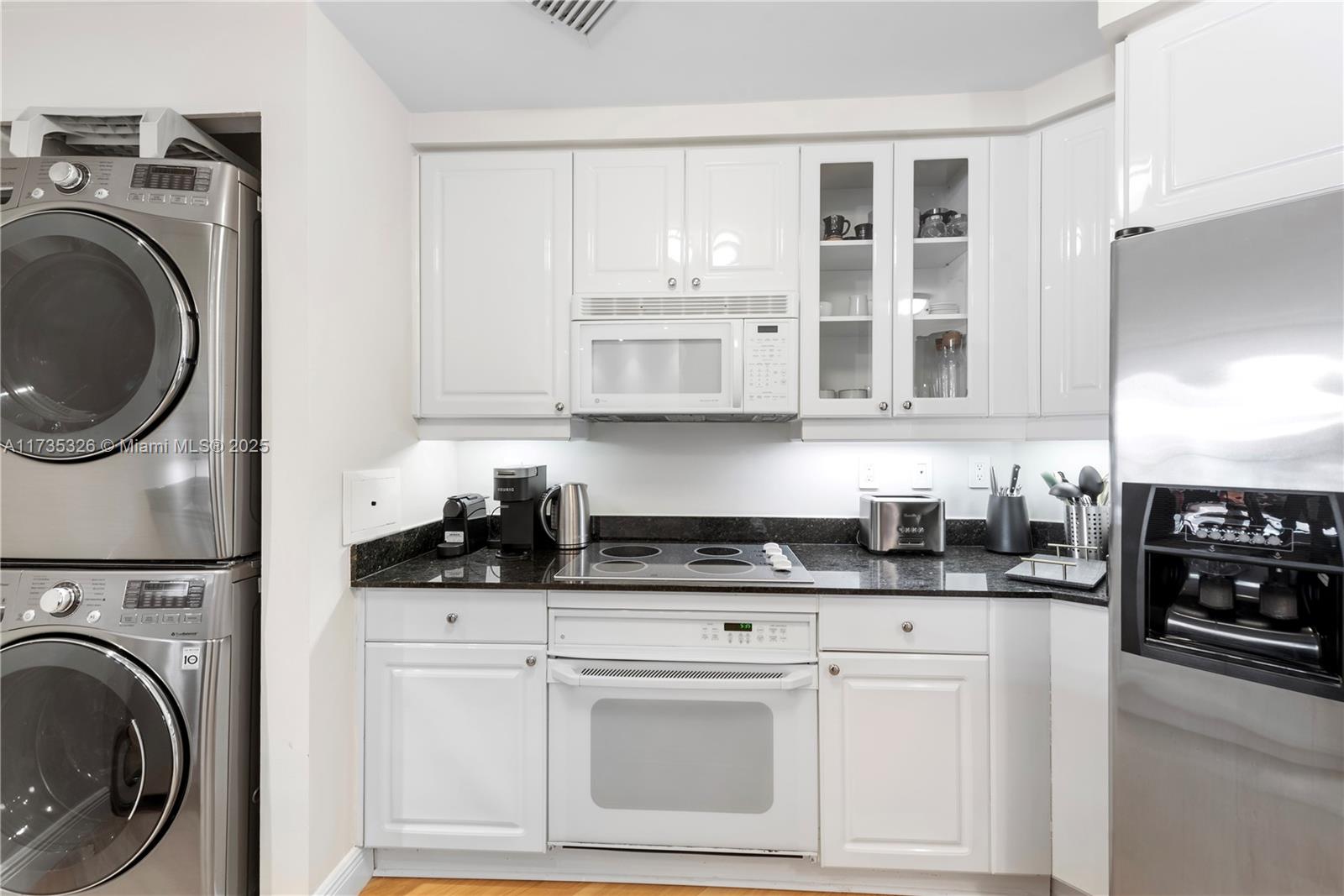 705 Crandon Boulevard, Unit 405 Key Biscayne, FL 33149 - Photo 12 of 29 a kitchen with stainless steel appliances granite countertop a sink a stove and cabinets