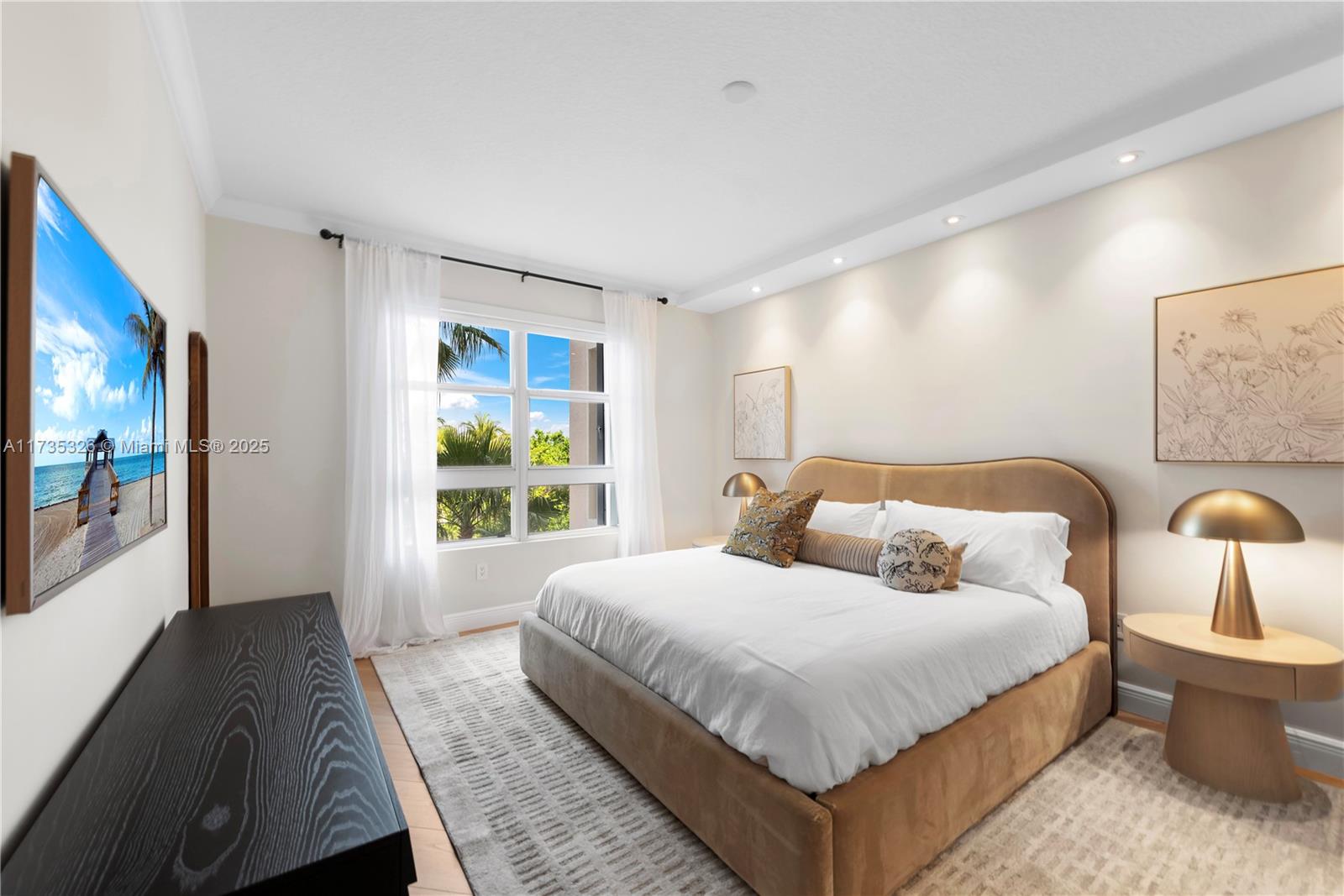 705 Crandon Boulevard, Unit 405 Key Biscayne, FL 33149 - Photo 17 of 29 a bedroom with a large bed and a window