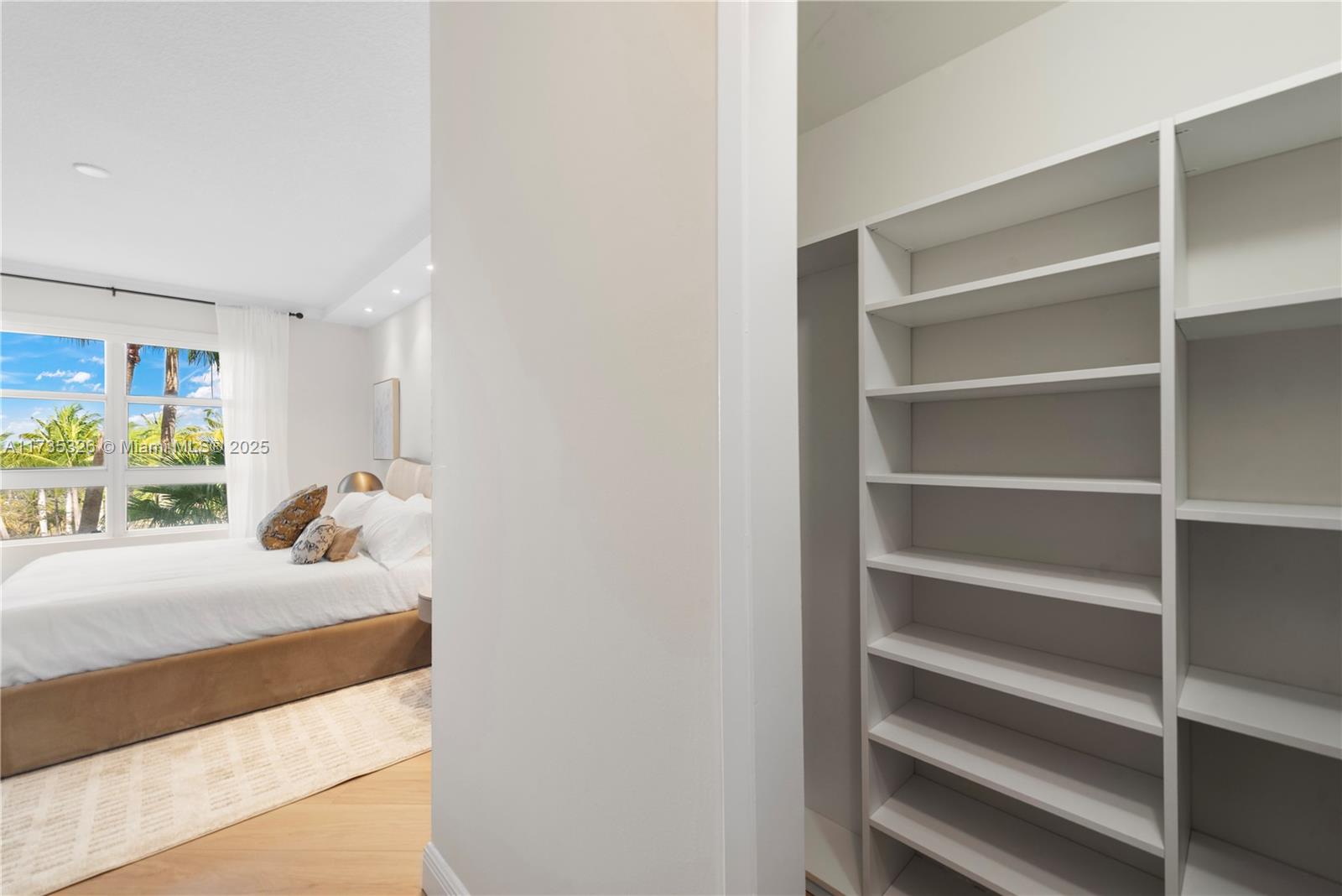 705 Crandon Boulevard, Unit 405 Key Biscayne, FL 33149 - Photo 18 of 29 a bedroom with a bed and a window