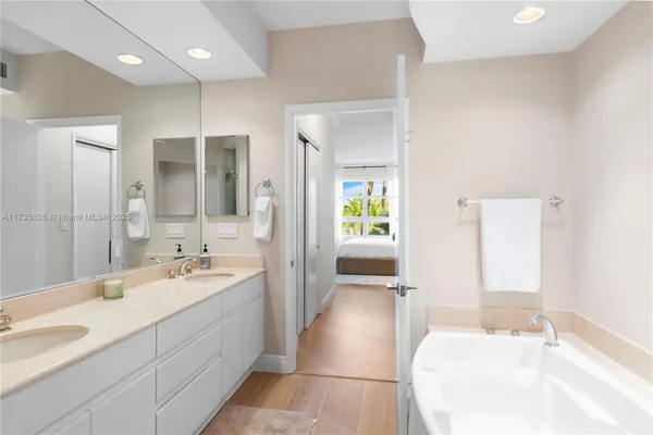a spacious bathroom with a double vanity sink mirror and double