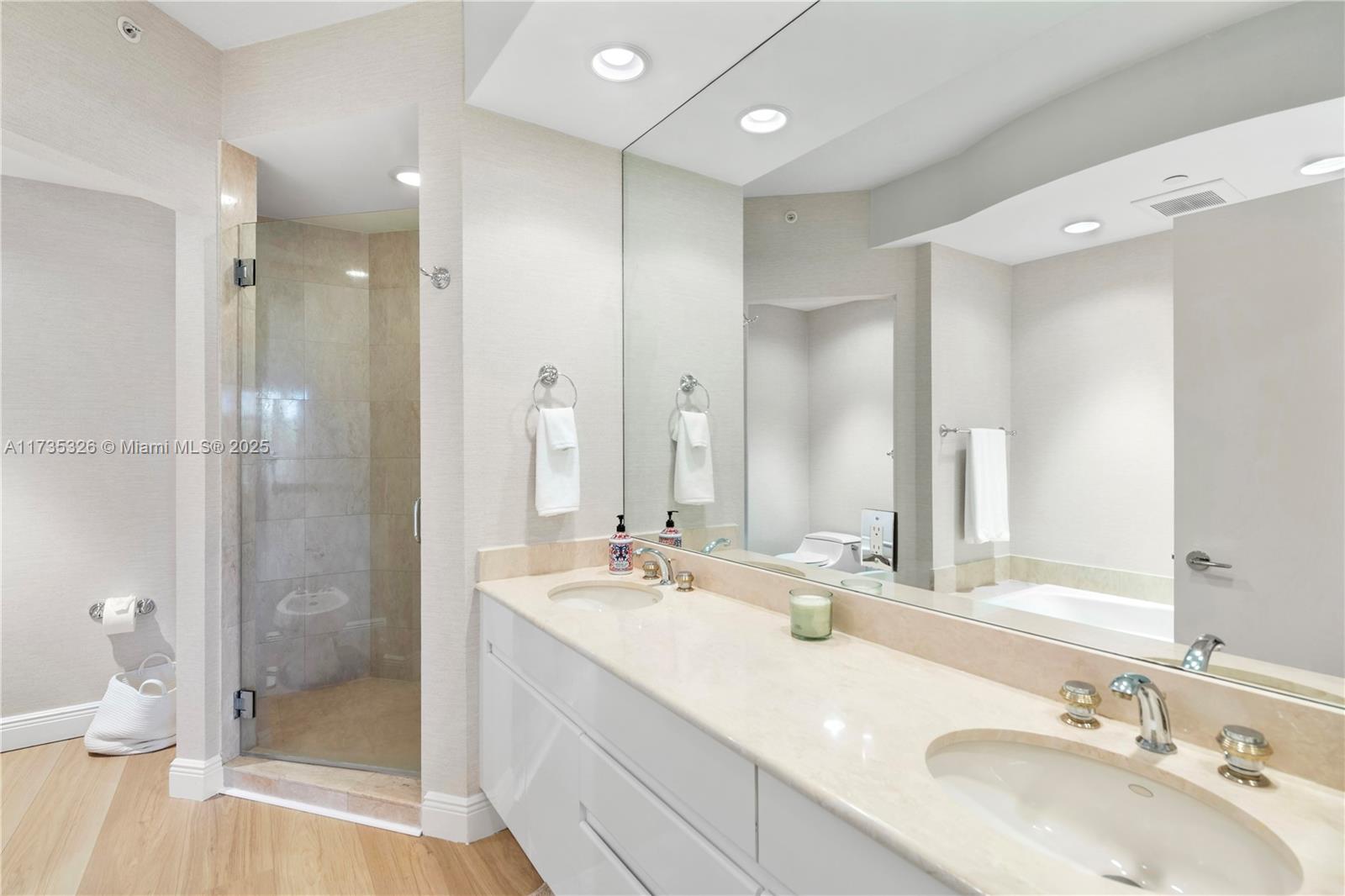 705 Crandon Boulevard, Unit 405 Key Biscayne, FL 33149 - Photo 20 of 29 a bathroom with a double vanity sink mirror and shower